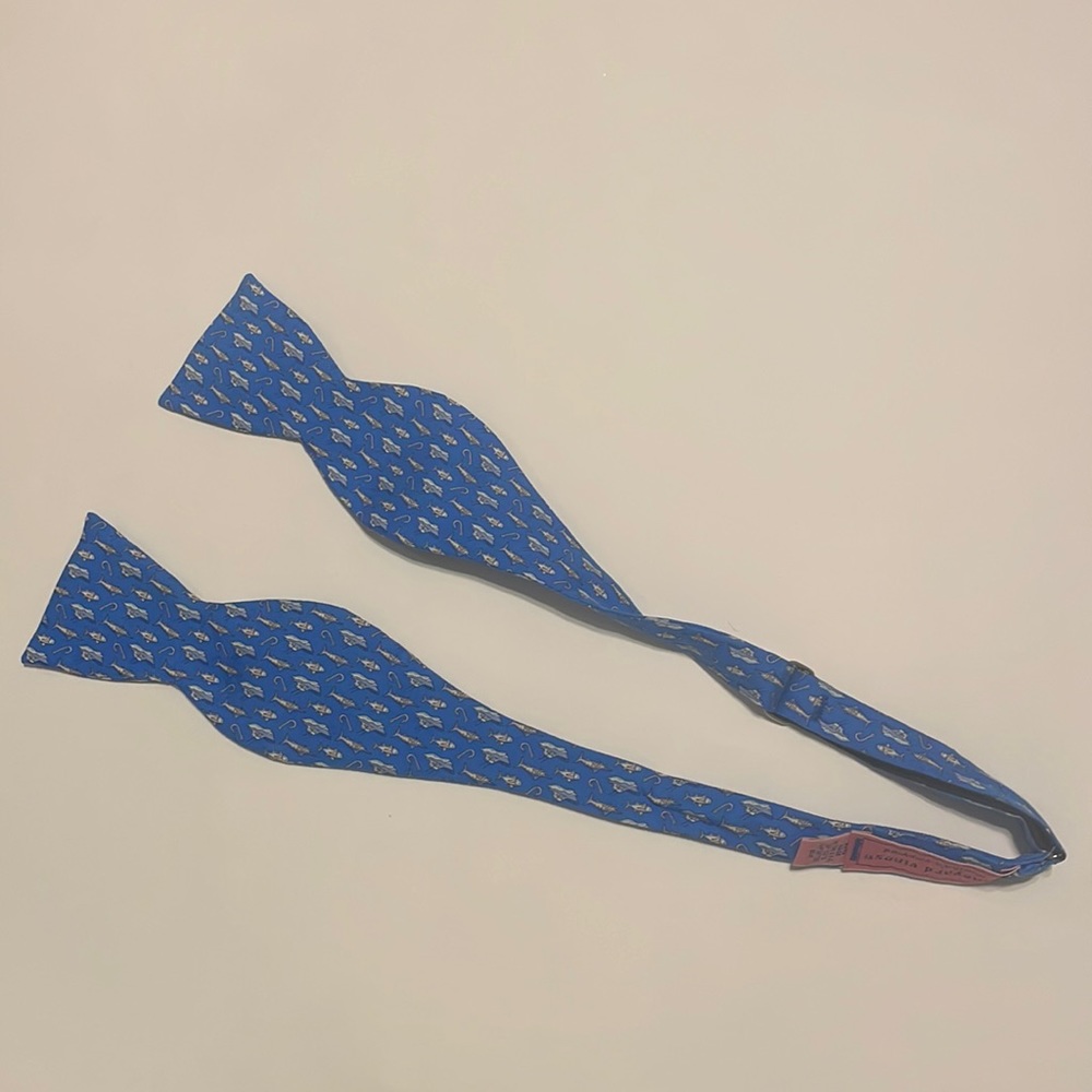 Vineyard Vines bow tie new with tags. It is blue with a boats, hooks, and fish.
